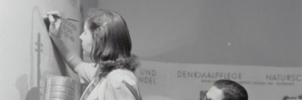 grayscale photo of man and woman standing beside boy